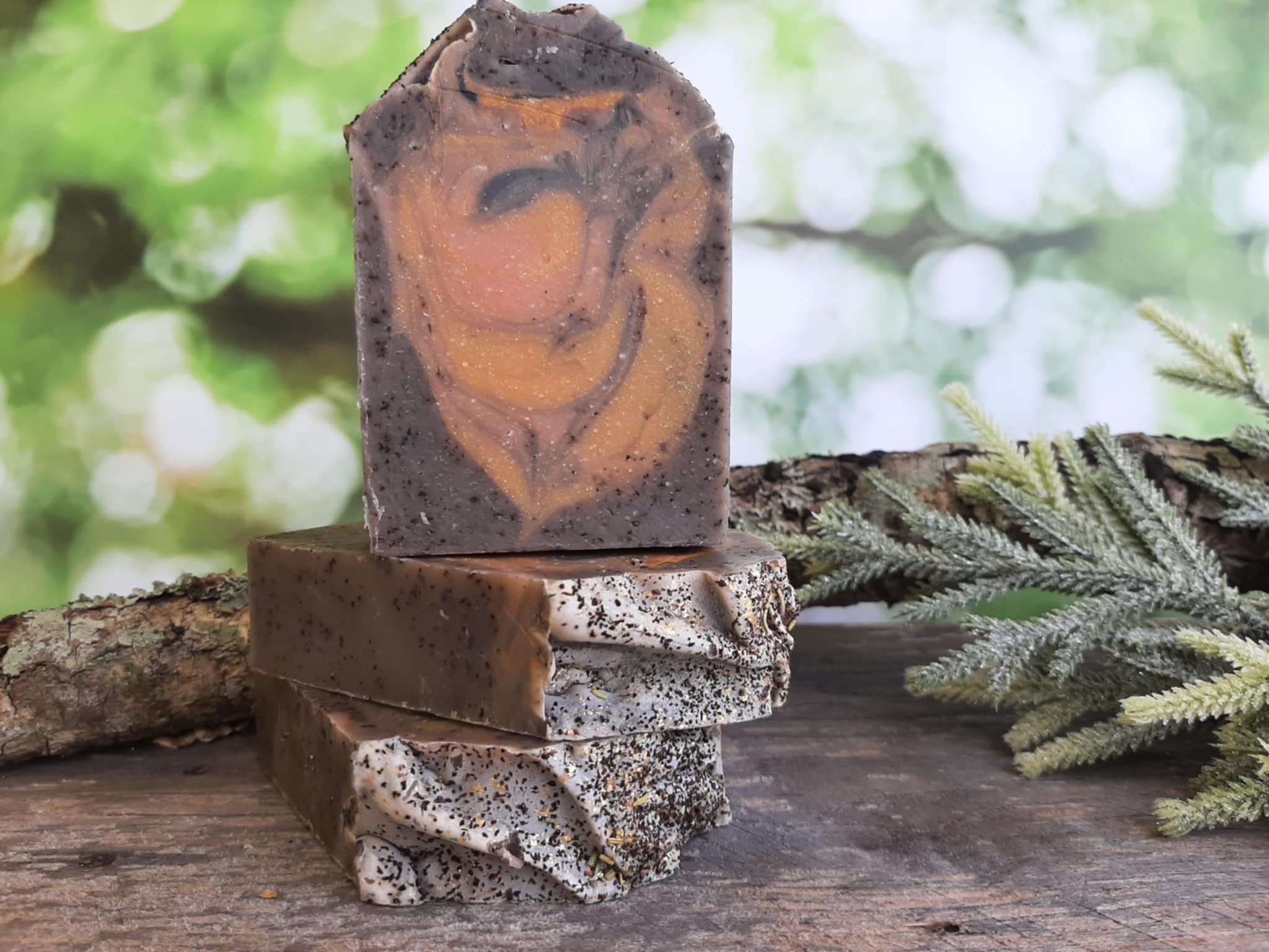 Handmade organic cedar and amber black tea body bar with embedded tea leaves and wood chips, rich amber hue, rustic soap on cedar plank