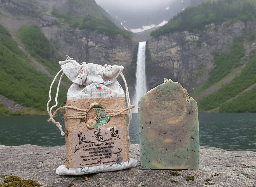 Handmade organic eucalyptus botanical body bar with embedded mint leaves and eucalyptus sprigs, textured natural soap on wooden dish, spa bathroom vibe