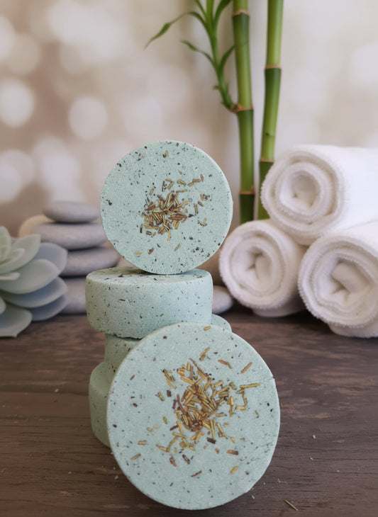 Handmade organic eucalyptus shower steamers in eco-friendly packaging, vibrant green hue from natural oils, aromatic spa-like bathroom essential