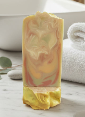 Handmade organic Lily Lemon Drop skincare gift set in kraft box with ribbon, featuring sugar scrub, bath bomb, and lotion bar, fresh lemon slices and lily petals