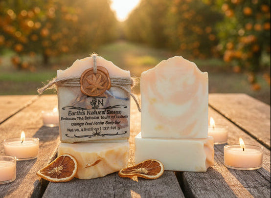 Handmade organic orange peel hemp body bar with dried orange zest and hemp seeds, sunny marbled swirl on white marble, fresh citrus spa vibe