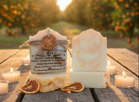 Handmade organic orange peel hemp body bar with dried orange zest and hemp seeds, sunny marbled swirl on white marble, fresh citrus spa vibe