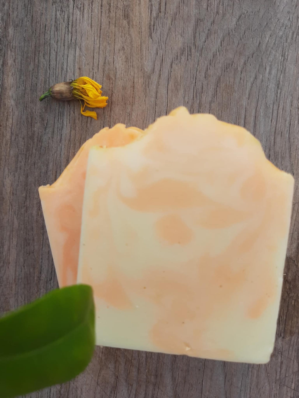 Flat lay: dried orange peel, hemp seeds, shea butter, fresh orange slice, coconut oil