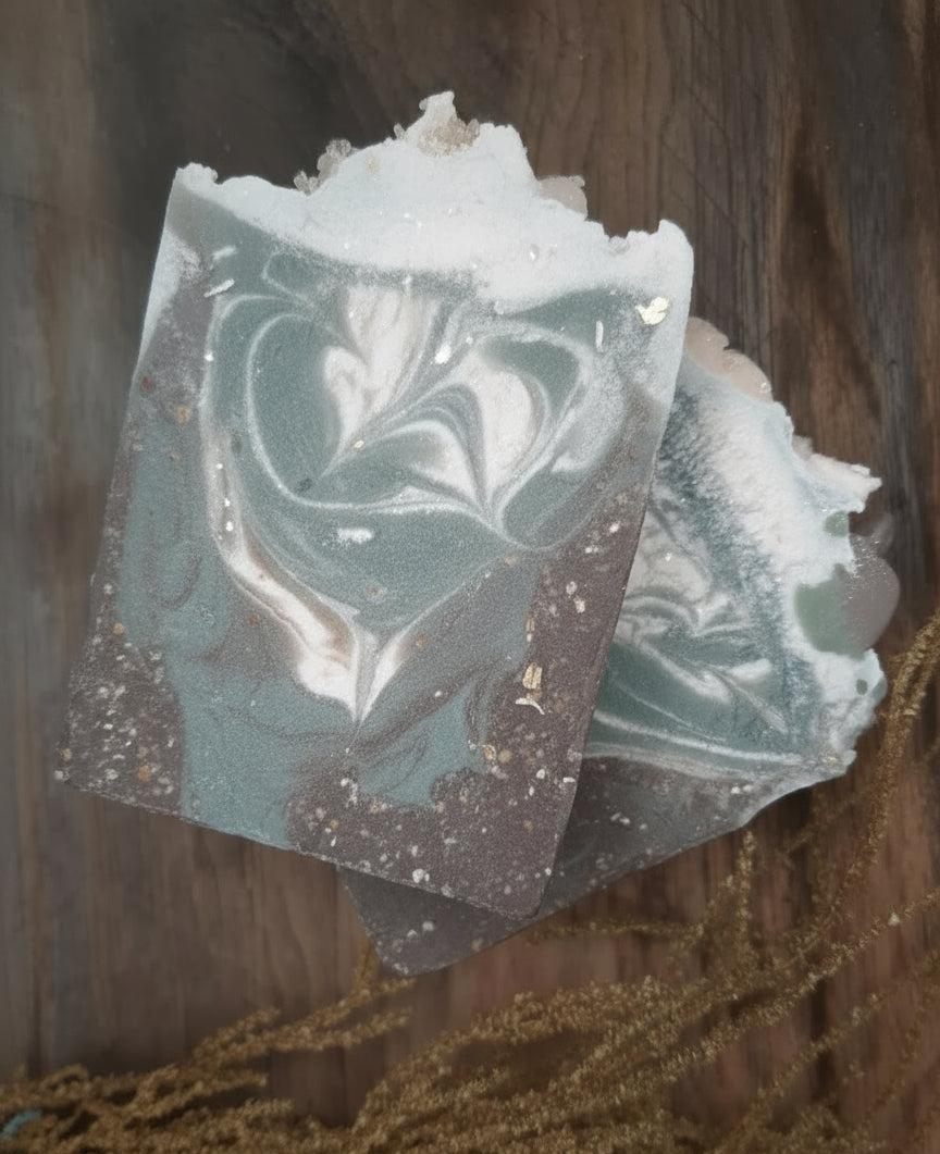 Handmade organic Ticket To Paradise aloe oatmeal hemp body bar with oat flecks and green swirls, tropical spa vibe on white linen with melon slice