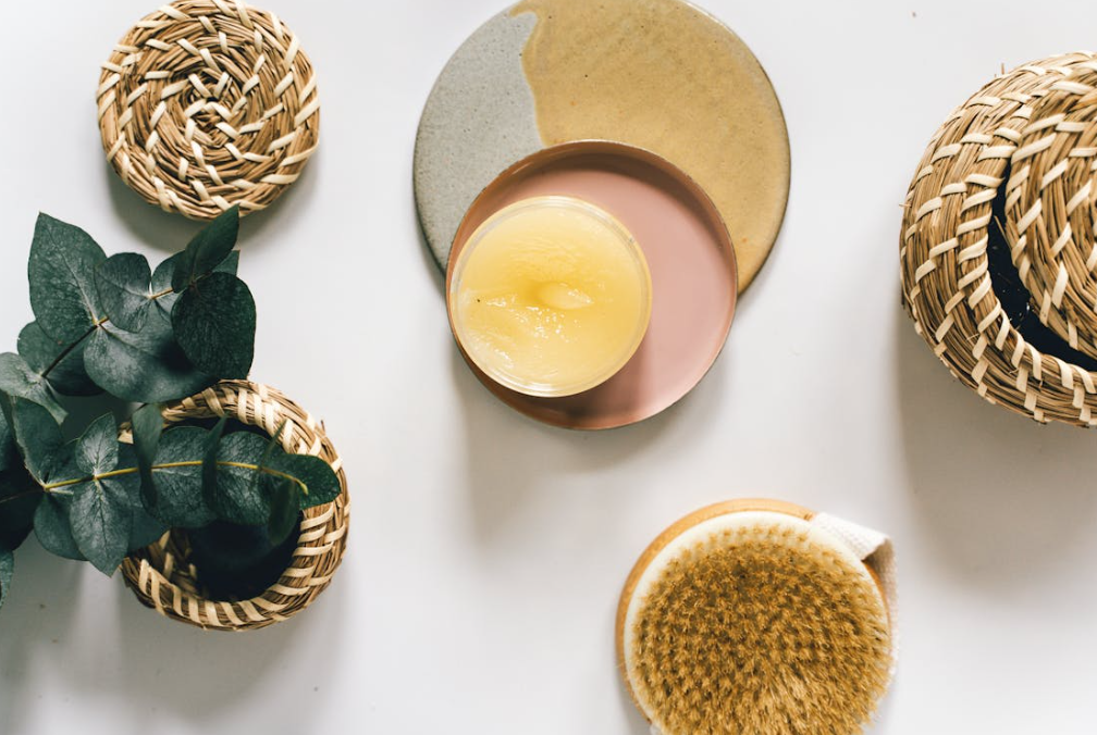 Handmade organic Lily Lemon Drop skincare gift set in kraft box with ribbon, featuring sugar scrub, bath bomb, and lotion bar, fresh lemon slices and lily petals